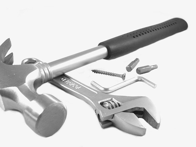 Tools including hammer, spanner, allen key on a white background